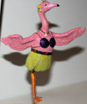 Before they made the leather flamingoes, we had Felipa, and her mate Felipe. They are the tourist flamingoes with that Las Vegas swing about them. They are early as the box states 2003. The flower on the side of her head is a nice touch, too.