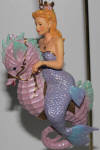 This is one of December Diamonds' classic mermaids. She isn't as tall as most of the others, but she has the class riding her seahorse with style. If the company hit a home run with Sand Dollar, then they had a grand slam with Sea Fan.