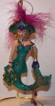 An awesome looking feathered mermaid. She has a nice peacock design on her tail, nice pink feathers with a greenish aqua body. It's better up close than what the picture shows.