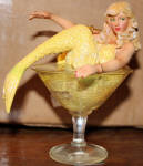 This is probably one of the most beautiful and sought after mermaids from December Diamonds. The model looks uncannily like Veronica Lake and that pose in the martini glass is completely sex kitten. This is absolutely classy! I see why this one is in so much demand from the collectors these days. 