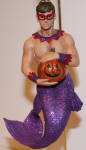 This merman is way in demand from collectors nowadays. He is the same year as Bones, and about the same scenario(merman dressed up for Halloween instead of a ghoul merman). Great purple fishtail, big glittered pumpkin, and mask, which reminds me of the boy wonder from Batman! He is a great essential merman to the collection
