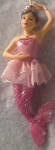 The ornament is one of the smaller ones they made. In a small ornament the detail is amazing. This is one of the rarer mermaids as I only seen it once for auction on Ebay in the past 4 years. The tutu she is wearing is a textured cloth which adds to it's uniqueness. A wonderful mermaid.