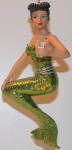 Gin has that Joan Crawford hairdo. I can hear her now�.TINA! Bring the axe! She's the mermaid counterpart to Tonic merman. I like the shade of green on her tail, and it looks better than the picture shows.