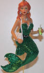 I like Soda. She has a very pretty mermaid face, and her green tail shimmers nicely. The pictures won't do much justice showing that here. She is Scotch's counterpart and they both have nice red hair coloring. They go great for St. Patrick's Day.